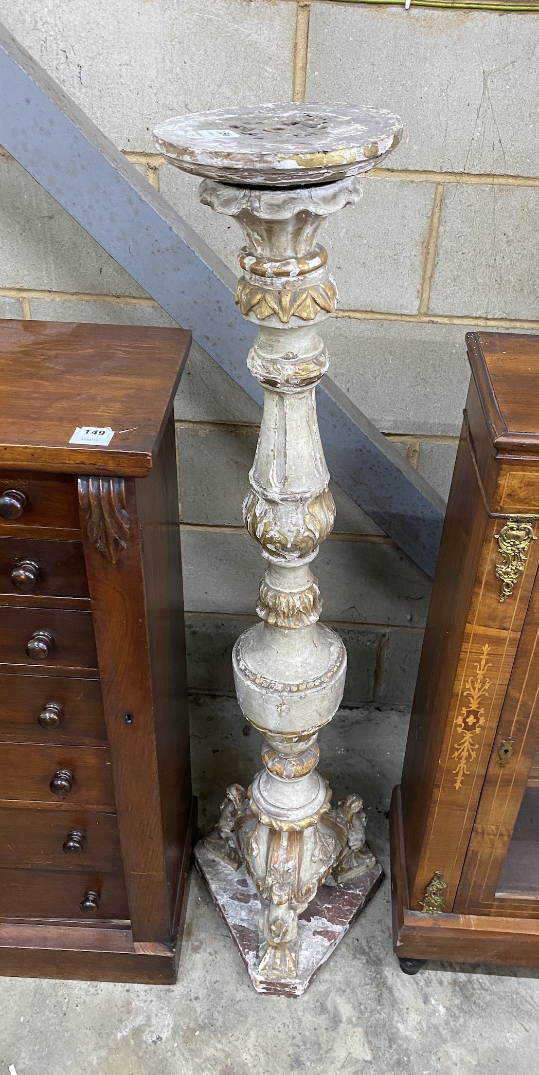 An 18th century style Italian carved wood parcel gilt torchere, height 132cm